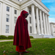 A protester dons a red cloak and white wings to protest Alabama’s recent near-total abortion ban.